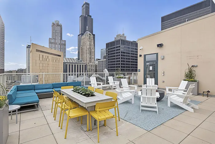 Rooftop dining set with view of the Chicago Skyline at Arc at Old Colony